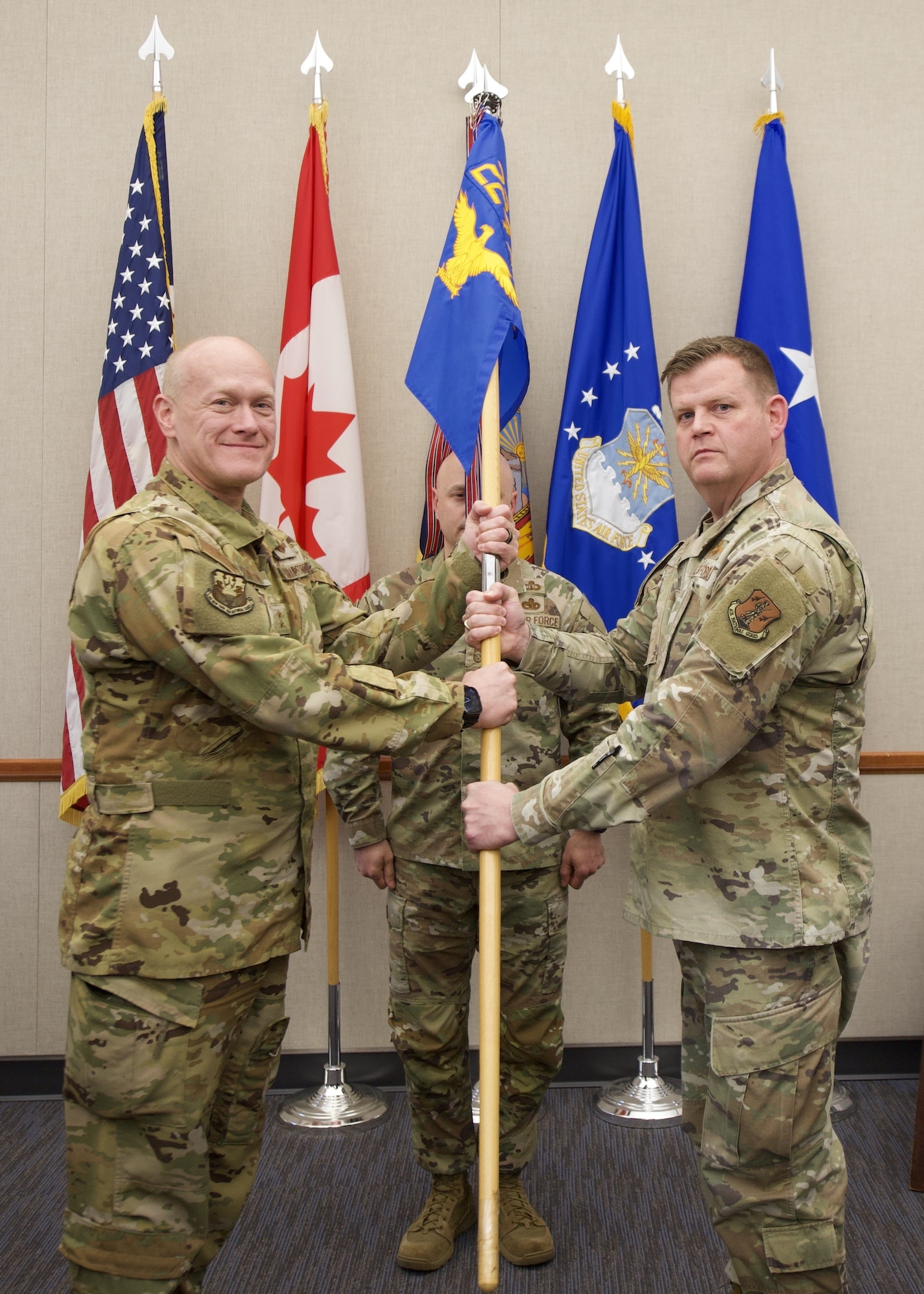 Col. Joseph J. Miller, Jr., right, takes the 224th Air Defense Group guidon from Maj. Gen. Charlton, the New York Air National Guard commander, during an assumption of command ceremony on April 23 at the Eastern Air Defense Sector in Rome. The guidon exchange serves as the ceremony’s centerpiece and symbolizes the passing of command to a new commander. Chief Master Sgt. Geoffrey Dooley, the 224th ADS Senior Enlisted Leader, was the guidon bearer and is pictured in the center.