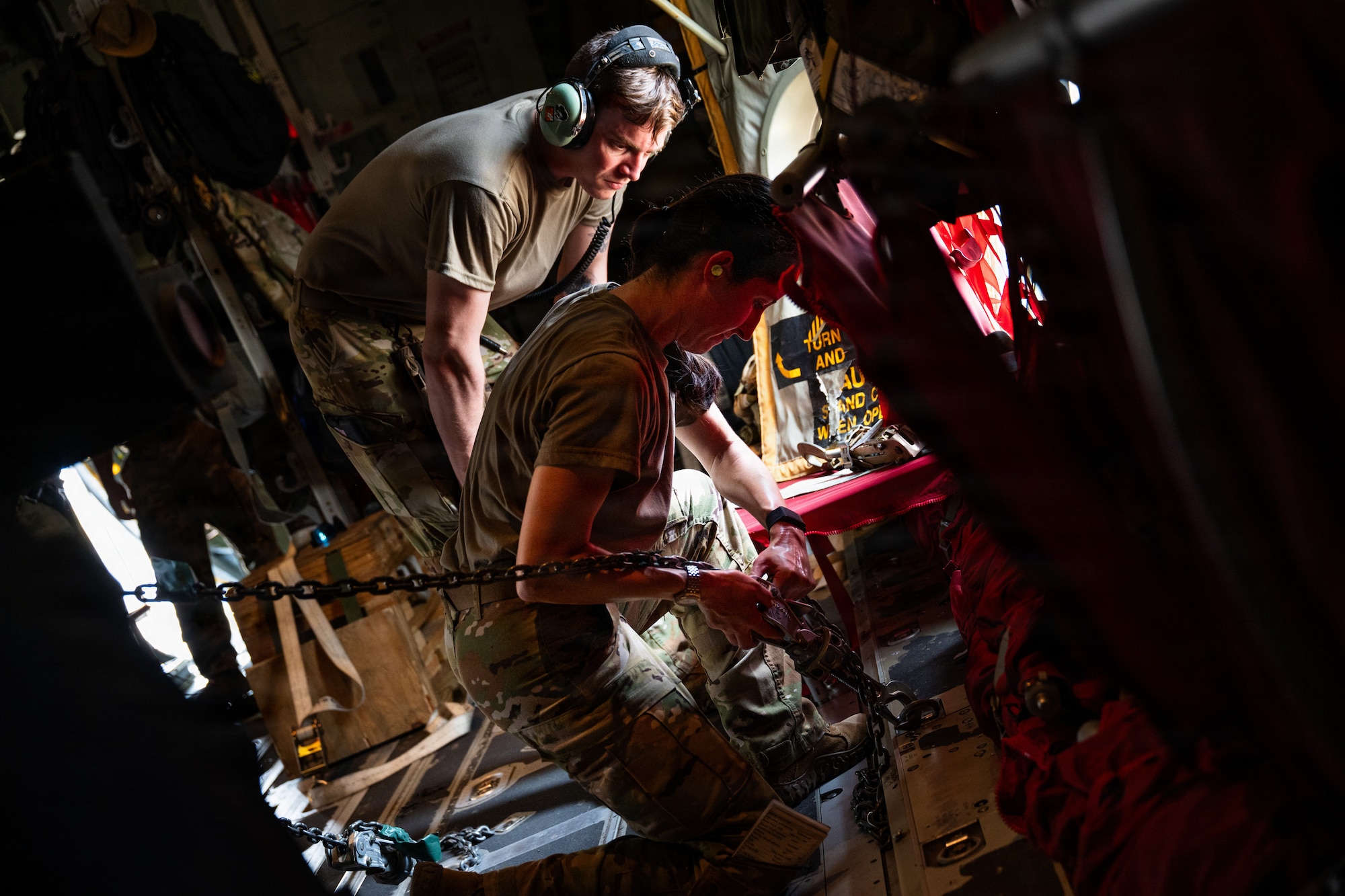 Airmen and Soldiers load a High Mobility Artillery Rocket System into a C-130 cargo plane