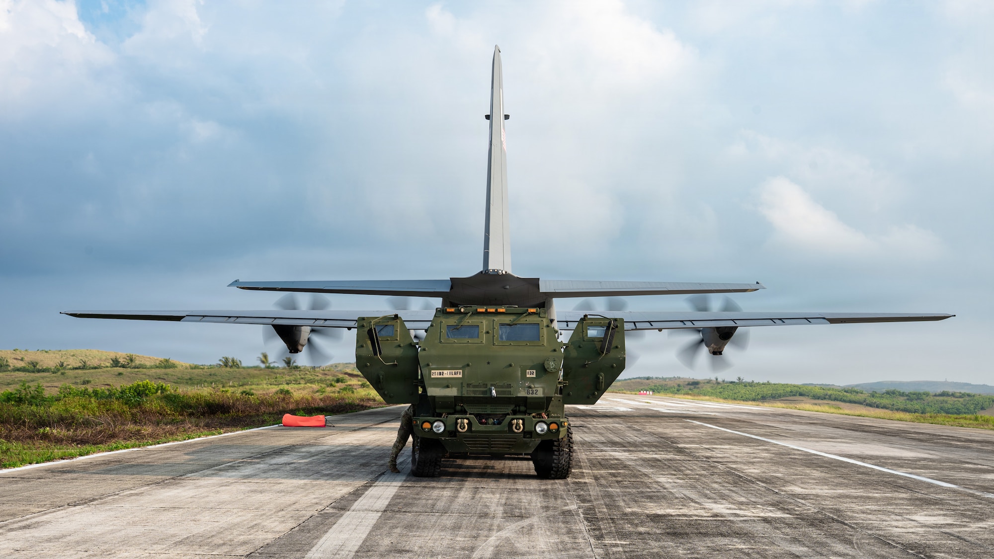 Airmen and Soldiers load a High Mobility Artillery Rocket System into a C-130 cargo plane