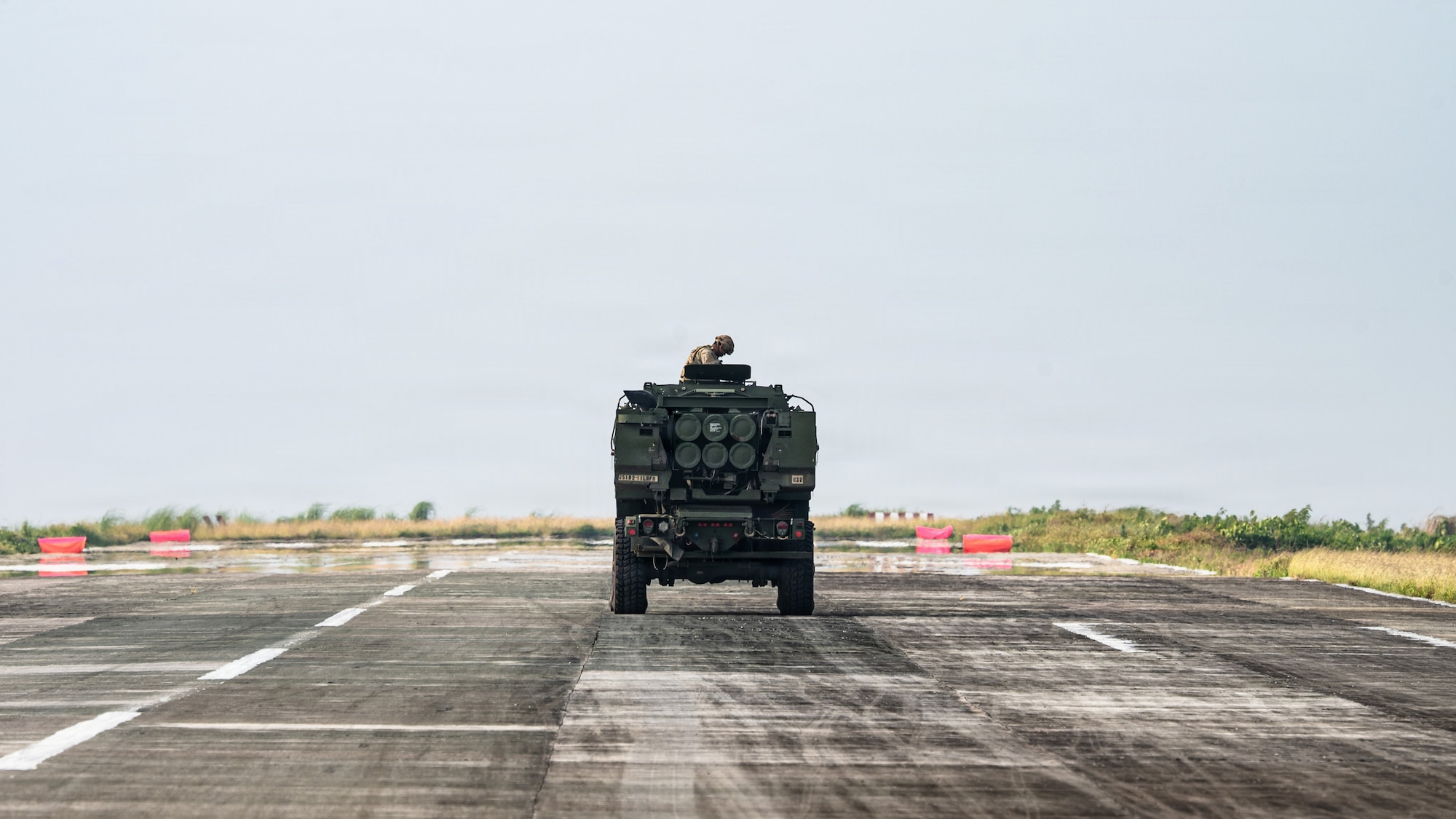 Airmen and Soldiers load a High Mobility Artillery Rocket System into a C-130 cargo plane