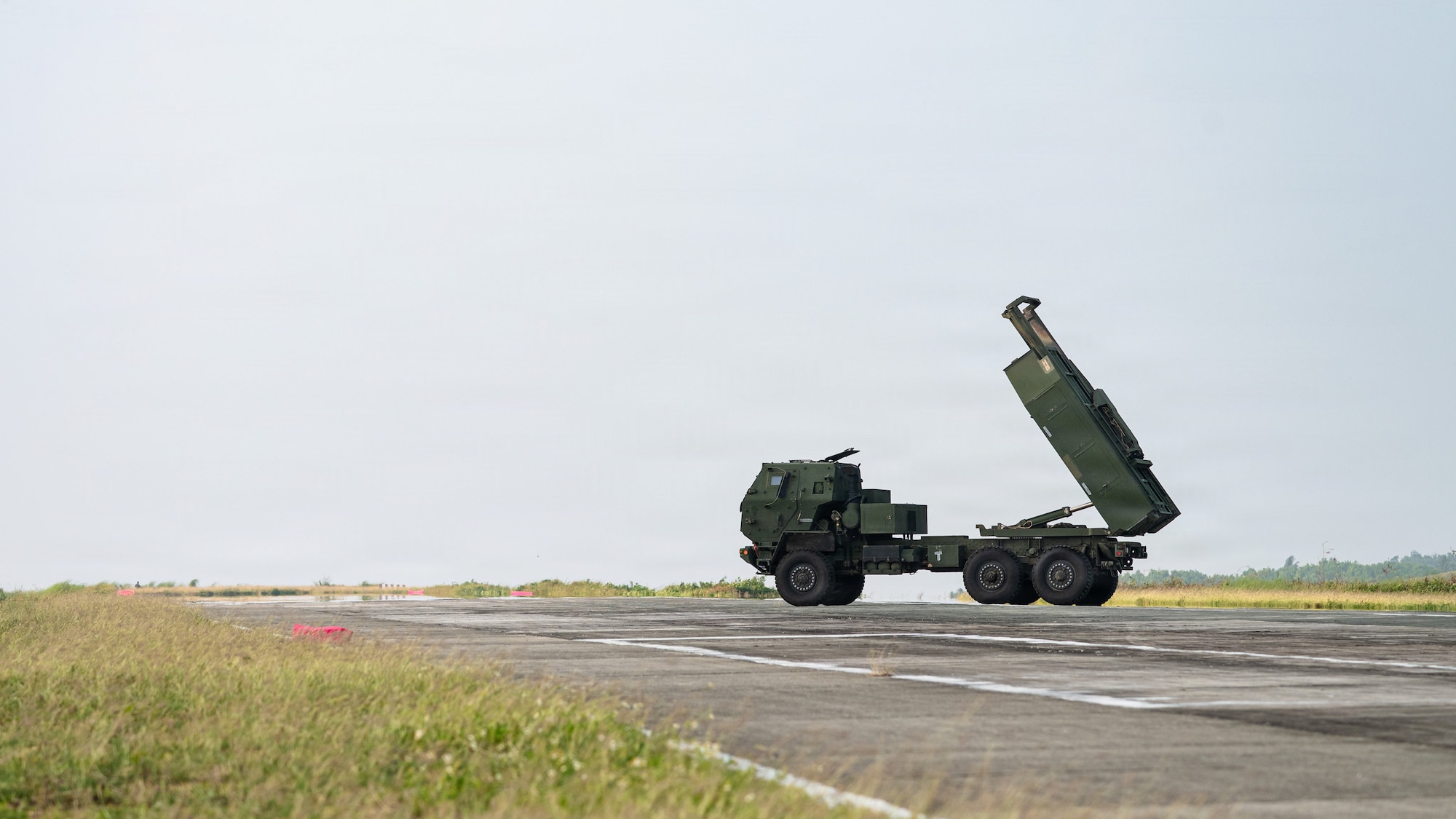 Airmen and Soldiers load a High Mobility Artillery Rocket System into a C-130 cargo plane