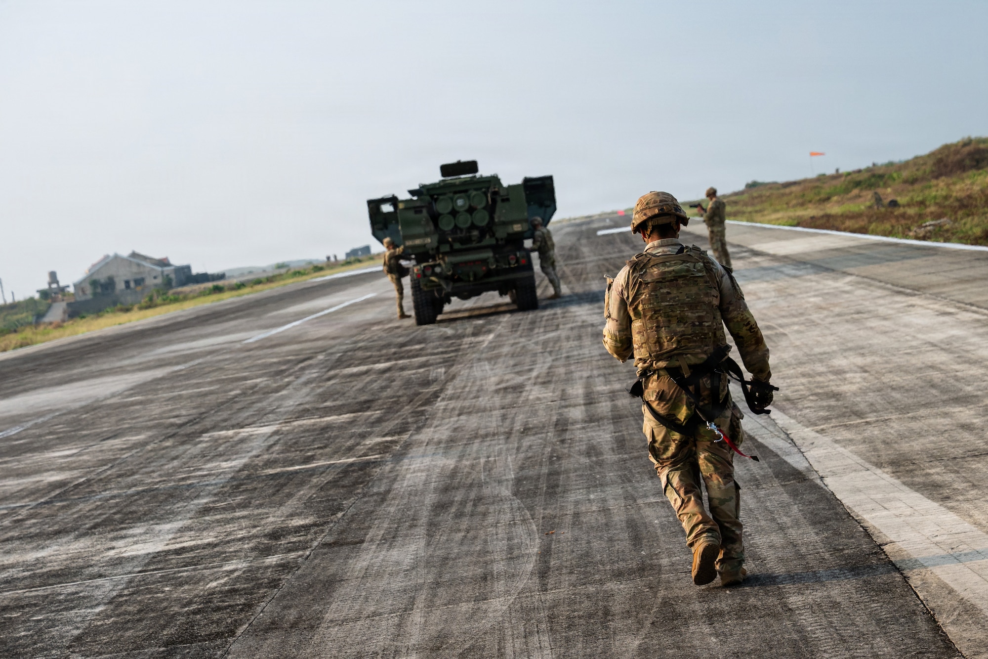 Airmen and Soldiers load a High Mobility Artillery Rocket System into a C-130 cargo plane