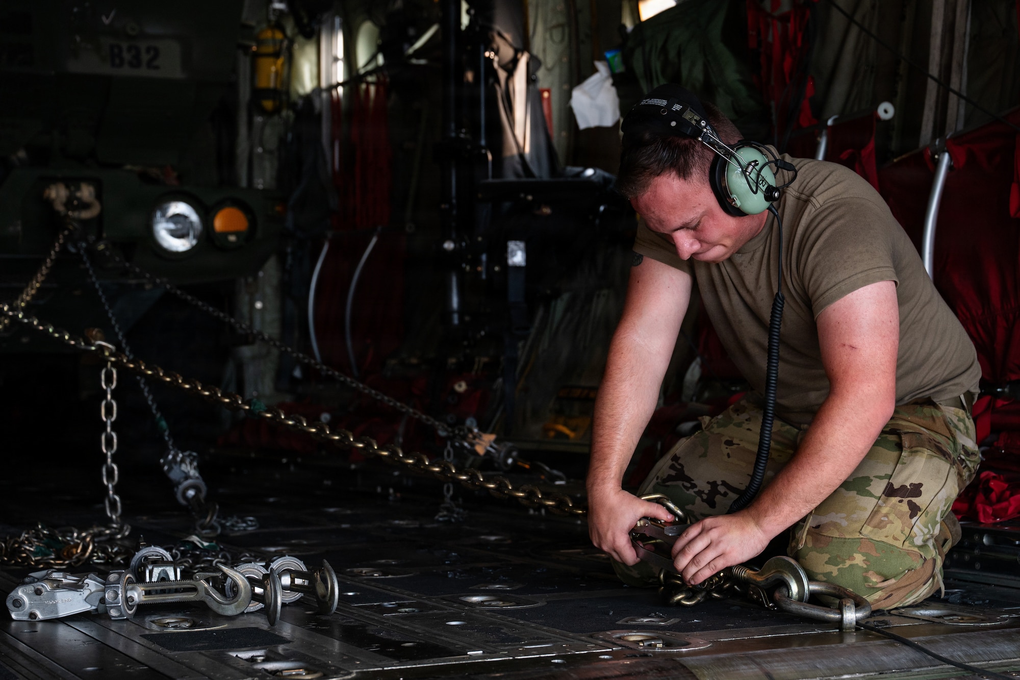 Airmen and Soldiers load a High Mobility Artillery Rocket System into a C-130 cargo plane