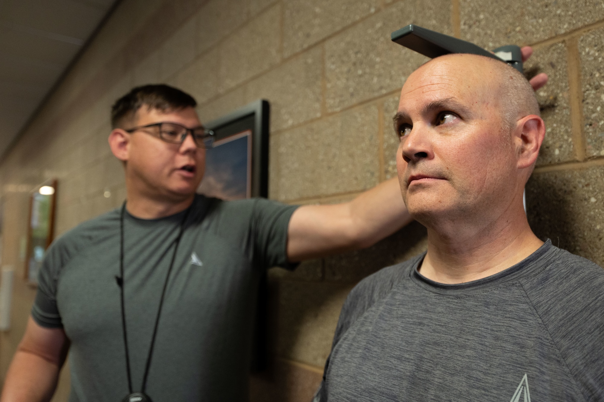 U.S. Space Force Master Sgt. Justin Neal, Space Forces Southern planner, left, measures the height of U.S. Space Force Col. Brandon Alford, Space Forces Southern commander, during a Human Performance Assessment at Davis-Monthan Air Force Base, Arizona, April 23, 2026. The HPA reflects a broader shift toward continuous, holistic fitness in the Space Force. (U.S. Air Force photo by Airman 1st Class Jaden Kidd)