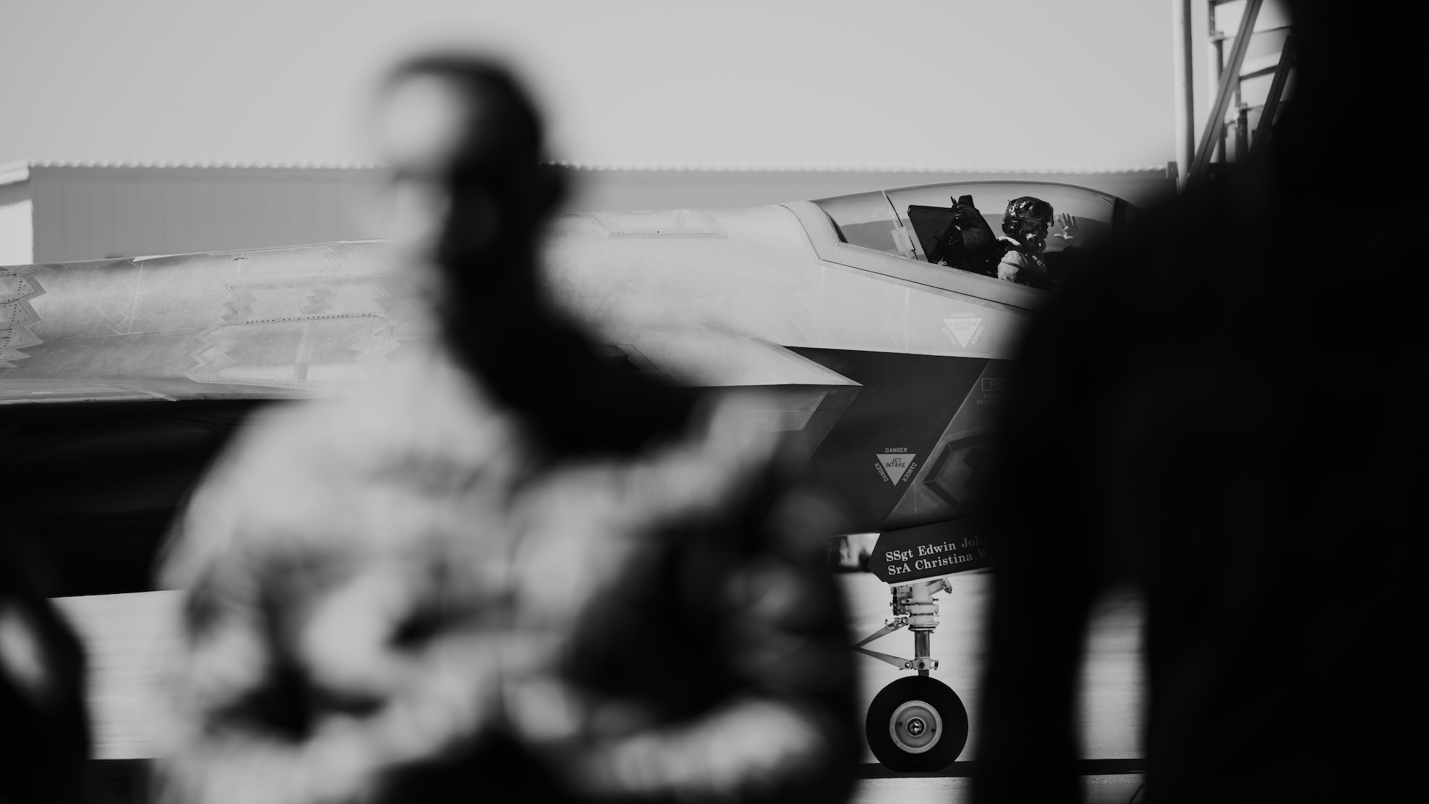 A U.S. Air Force F-35A Lightning II pilot waves as he passes the 56th Fighter Wing’s first quarter weapons load competition.