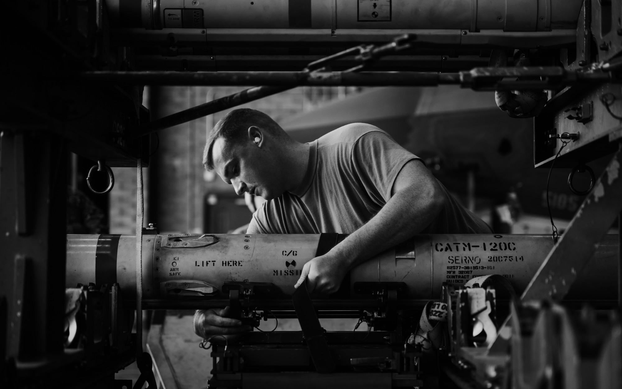 U.S. Air Force Staff Sgt. Russell Crew, 62nd Aircraft Maintenance Unit weapons load crew chief, examines training ordnance