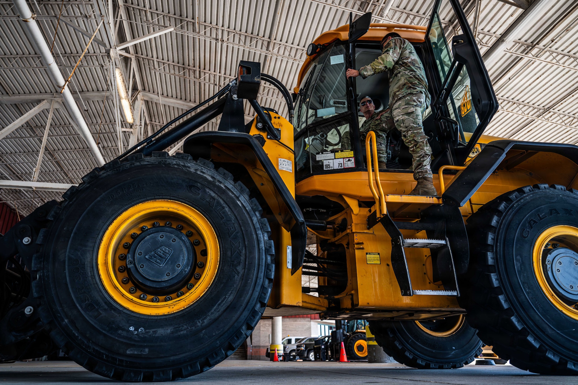 Men speak in forklift.