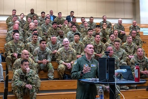 People sit on bleachers.