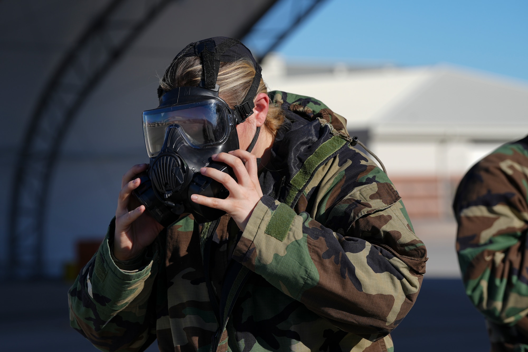 A U.S. Airman assigned to the 25th Aircraft Maintenance Squadron secures an M50 Joint Service General Purpose Mask during a training exercise at Creech Air Force Base, Nevada, Jan. 14, 2026.