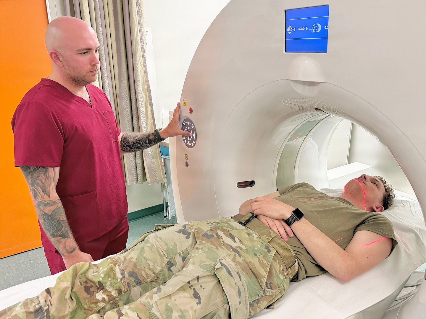 Technician performs CT Scan on patient.