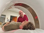 Technician performs CT Scan on patient.