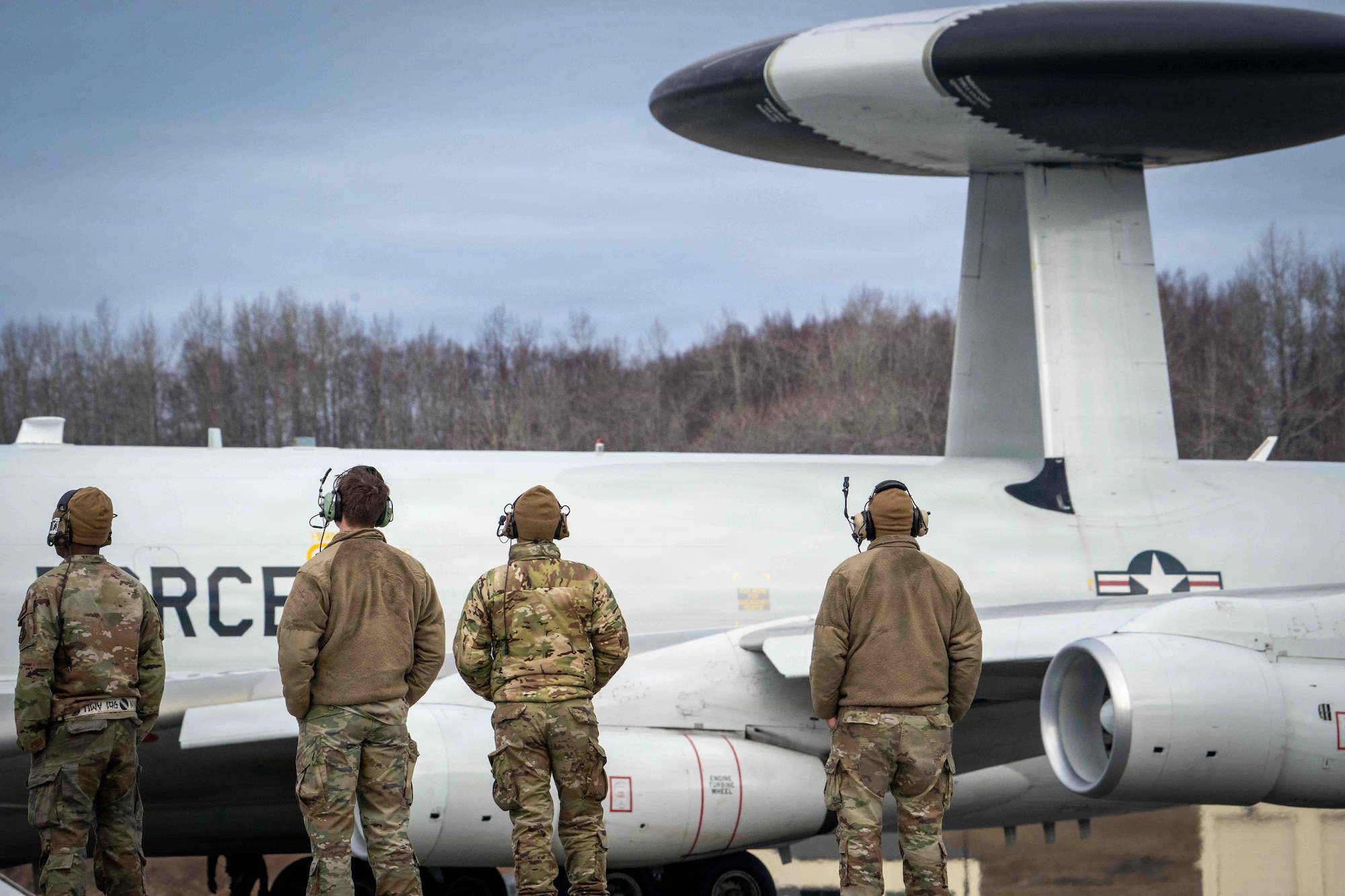 U.S. Air Force Airmen from the 718th Aircraft Maintenance Squadron and 961st Air Maintenance Unit watch an E-3 Sentry assigned to the 962nd Airborne Air Control Squadron taxi on the runway during Red Flag-Alaska 26-1 at Joint Base Elmendorf-Richardson, Alaska, April 23, 2026.