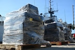 Bales of illegal narcotics are placed on pallets by crew members aboard USCGC Escanaba (907) during a drug offload of 7,050 pounds of cocaine at Port Everglades, Florida, April 27, 2026. The seized contraband was the result of one interdiction in the Caribbean Sea and one interdiction in the Eastern Pacific Ocean worth an estimated $53 million dollars. (U.S. Coast Guard photo by Petty Officer 2rd Class Eric Rodriguez)