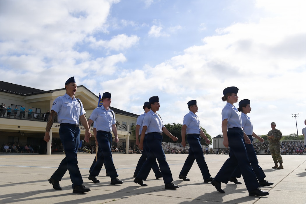 A group of military members march in formation.