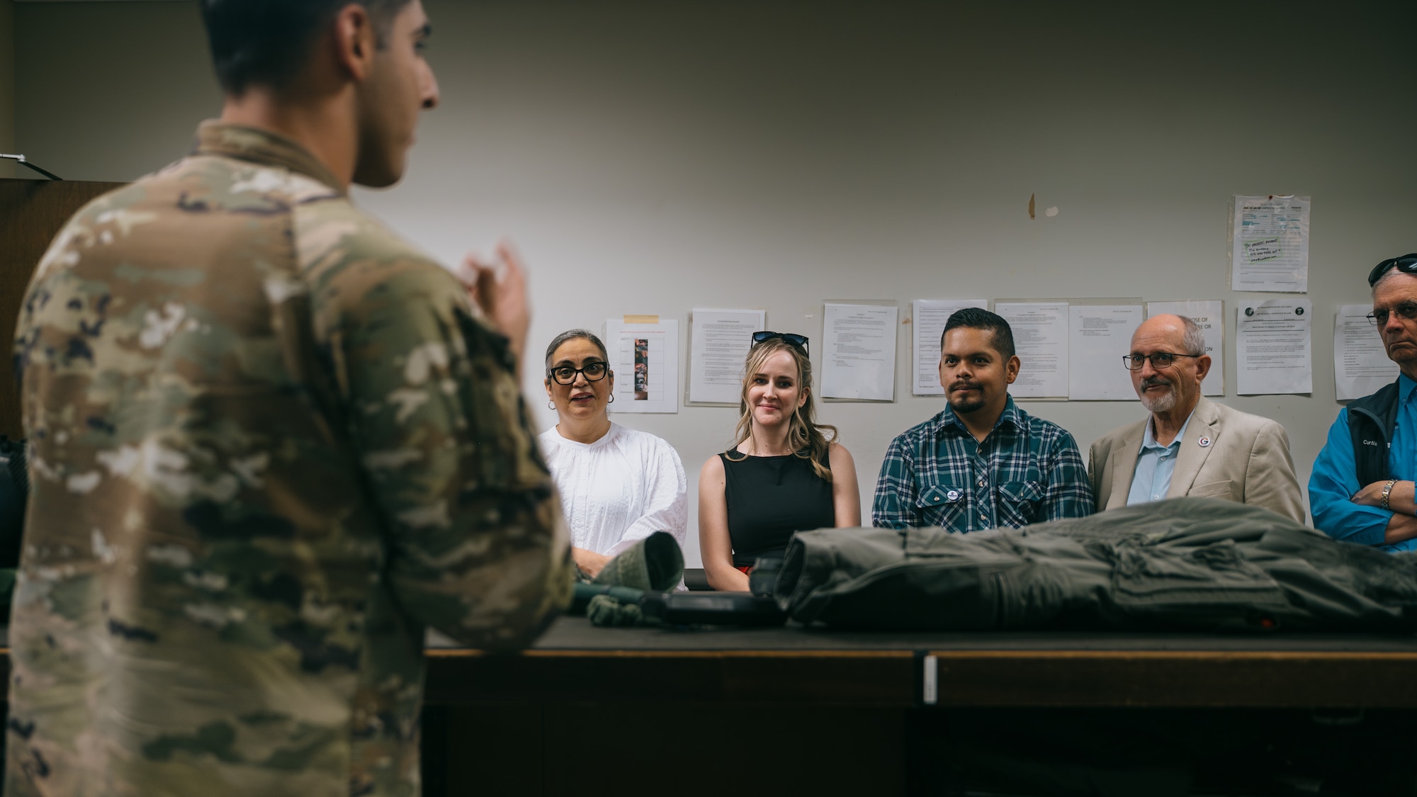 West Valley elected officials listen to a flight equipment briefing given by a U.S. Air Force aircrew flight equipment specialist.