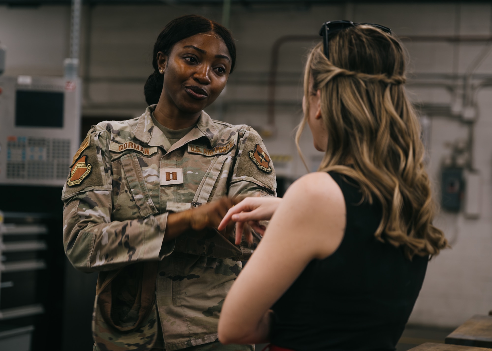 U.S. Air Force Capt. Beatrice Gorman, 56th Fighter Wing community liaison officer, speaks to Ginna Carico