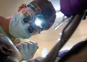 U.S. Air Force Reserve Maj. Kelsey Geiger, 434th Aerospace Medicine Squadron dentist, extracts a patient’s tooth during the Lesser Antilles Medical Assistance Team (LAMAT) 2026 mission at Medische Zending Primary Health Care Center Brownsweg, Suriname, April 14, 2026. Care focused on relieving pain and treating infection while supporting LAMAT 2026’s goal of improving access to care and strengthening regional partnerships. (U.S. Air Force photo by Staff Sgt. Madeline Herzog)