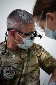 U.S. Air Force Lt. Col. Matthew Heineman, 434th Aerospace Medicine Squadron dentist, examines a patient during the Lesser Antilles Medical Assistance Team mission at Mungra Medical Centre, Nickerie, April 13, 2026. The LAMAT mission brings together 47 U.S. medical practitioners and support personnel with expertise in primary care, optometry, dental care and logistics to locations across Suriname, where they work to provide improved care for patients while strengthening relationships with host nation counterparts. (U.S. Air Force photo by Capt. Danny Rangel)