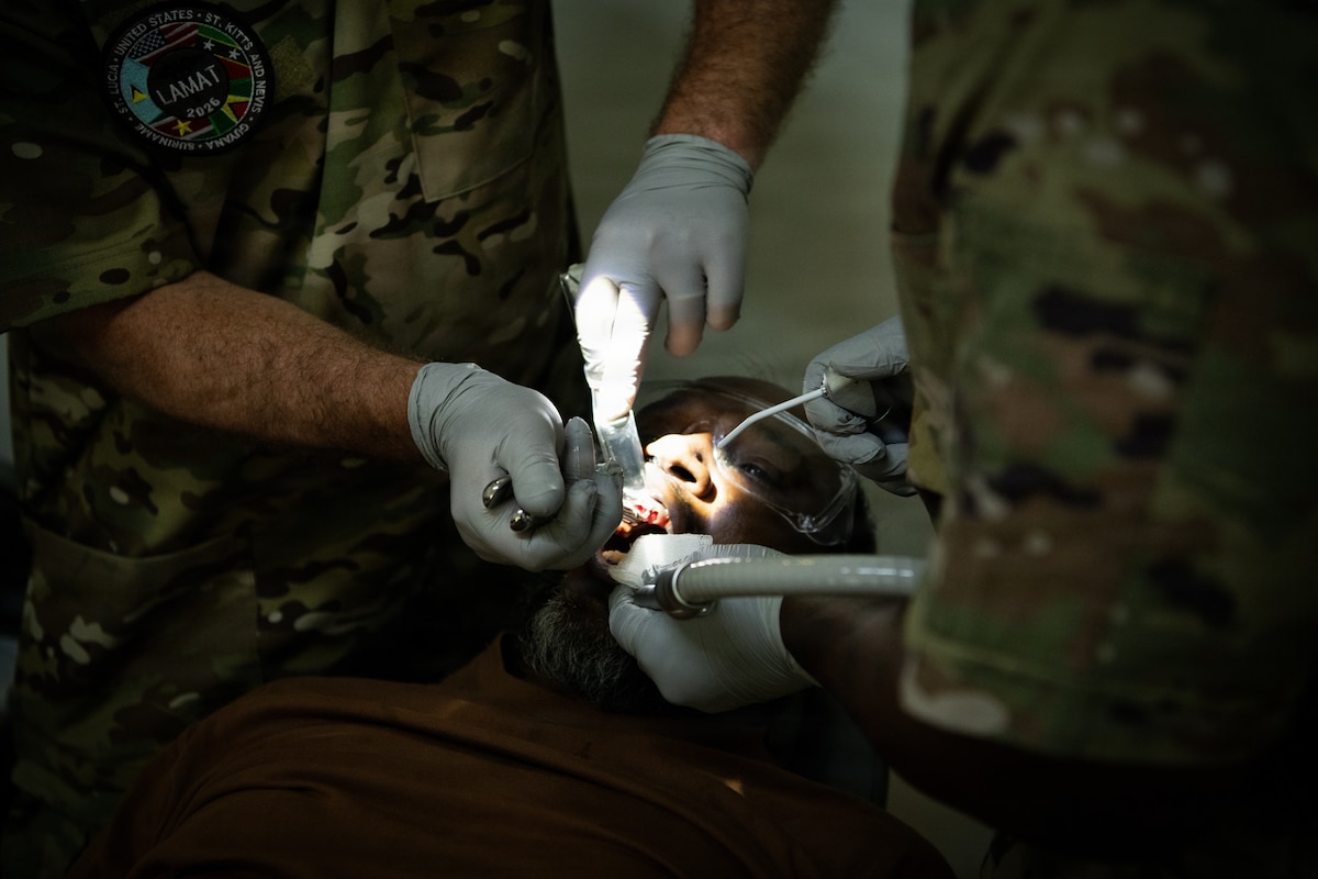 U.S. Air Force Lt. Col. Matthew Heineman, 434th Aerospace Medicine Squadron dentist, extracts a tooth from a patient during the Lesser Antilles Medical Assistance Team mission at Mungra Medical Centre, Nickerie, April 13, 2026. The LAMAT mission brings together 47 U.S. medical practitioners and support personnel with expertise in primary care, optometry, dental care and logistics to locations across Suriname, where they work to provide improved care for patients while strengthening relationships with host nation counterparts. (U.S. Air Force photo by Capt. Danny Rangel)