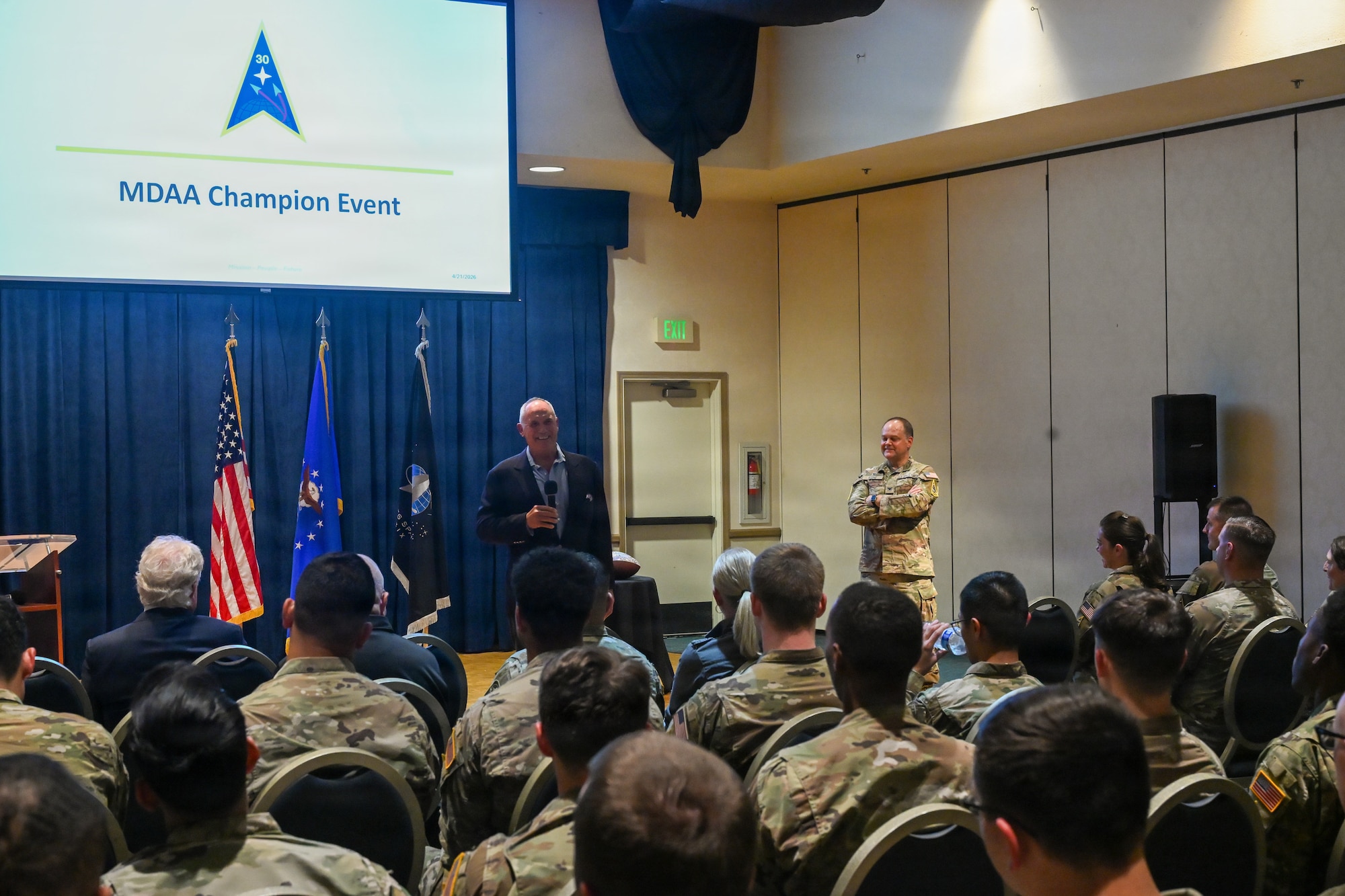 Man speaks to a crowd of people.