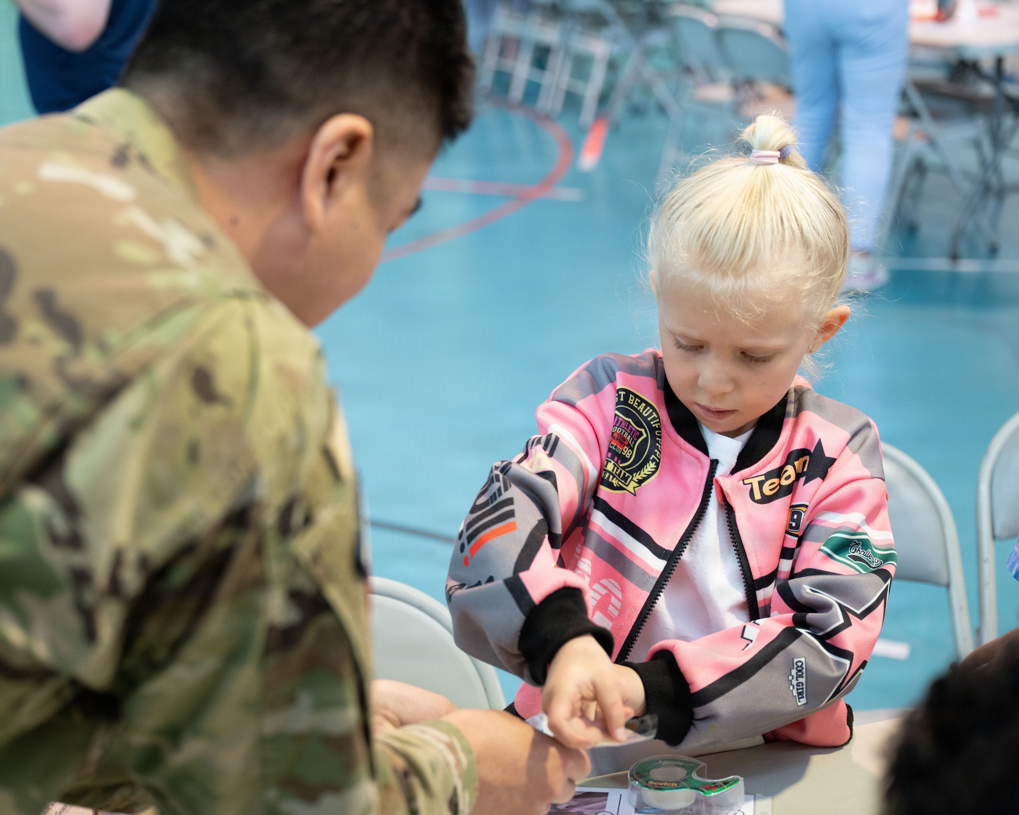 U.S. Space Force Lt. Col. Kaoru Elliott, United Space Forces-Japan deputy commander, engages with elementary school students during a Space Systems Command outreach event at Yokota Air Base, Japan, March 25, 2026. SSC’s outreach program connects students with real-world space applications, strengthening public understanding of space missions and the U.S. Space Force’s role in national defense. (U.S. Air Force photo by Senior Airman Jacob Wood)