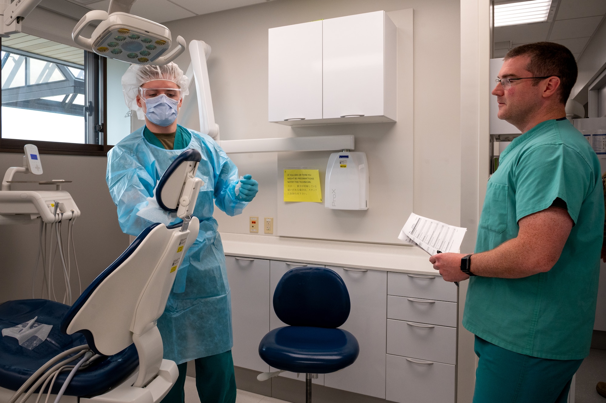U.S. Air Force Staff Sgt. William Garrett, 35th Medical Group Non-Commission officer in charge of records and reception, observes Senior Airman Benjamin Smith, 35th Medical Group dental assistant,  as he sanitizes a patient chair during tracer observation training  at Misawa Air Base, Japan, April 16, 2026.