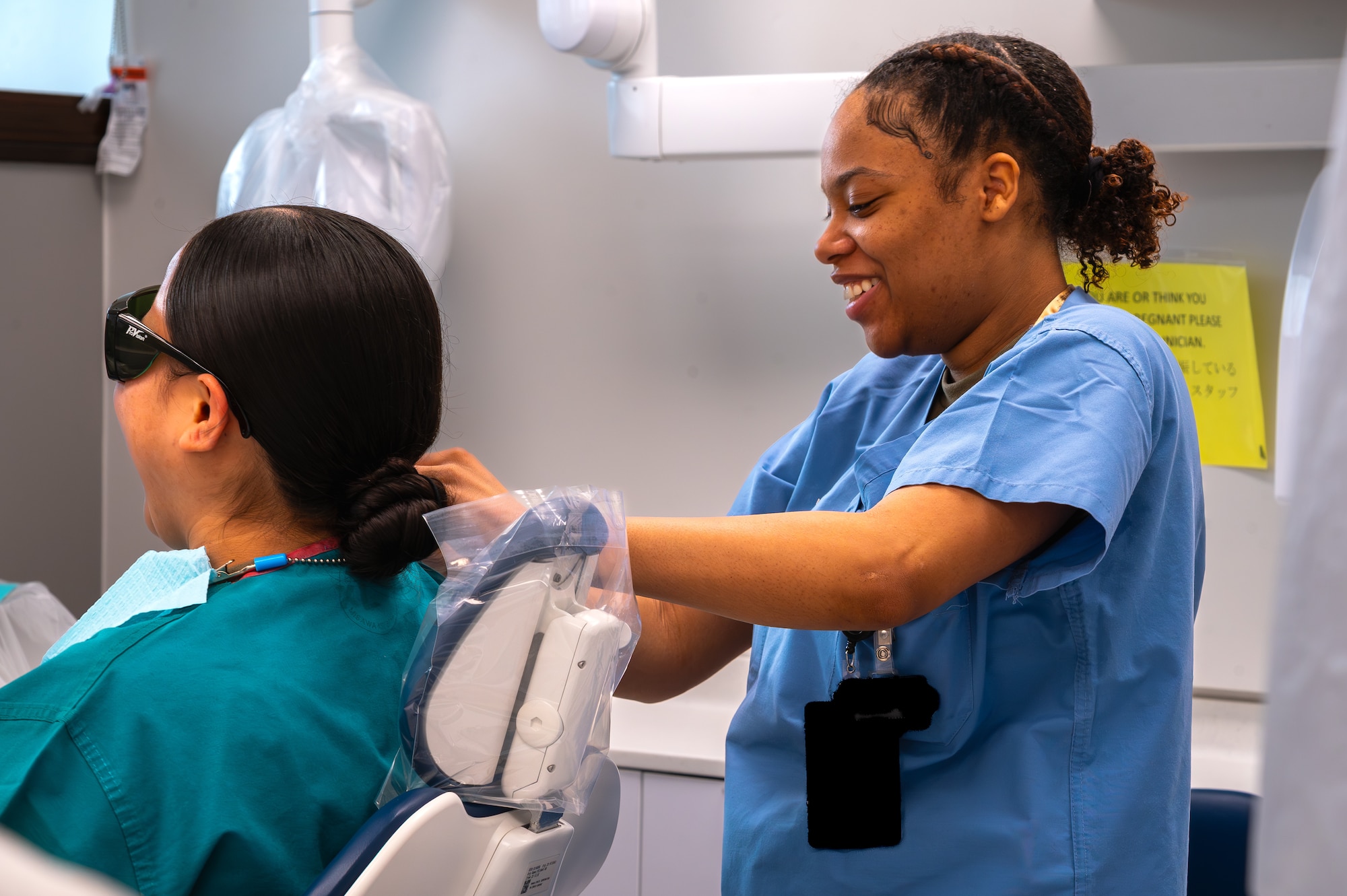 U.S. Air Force Airman Layla Lacour, 35th Medical Group dental assistant, places a dental napkin on Airman 1st Class Davina Ioane, 35th Medical Group dental technician during tracer observation training at Misawa Air Base, Japan, April 16, 2026.