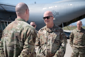 Airmen speak to one another on the flightline.