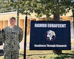 SIGONELLA, Italy (April 7, 2026) Cmdr. Micah Kinney, executive officer, Naval Medical Research Unit (NAMRU) EURAFCENT, poses outside of the command headquarters. Kinney supports military medical research in his role by collaborating with various commands and mission partners. NAMRU EURAFCENT, part of Navy Medicine Research & Development, conducts research, surveillance and studies of vaccines, therapeutic agents, diagnostic assays and vector control measures in the EUCOM, AFRICOM and CENTCOM Areas of Responsibility to better prevent and treat infectious diseases in support of Navy, Marine Corps and joint U.S. warfighter health, readiness and lethality. (U.S. Navy photo taken by Enya Williams/Released)