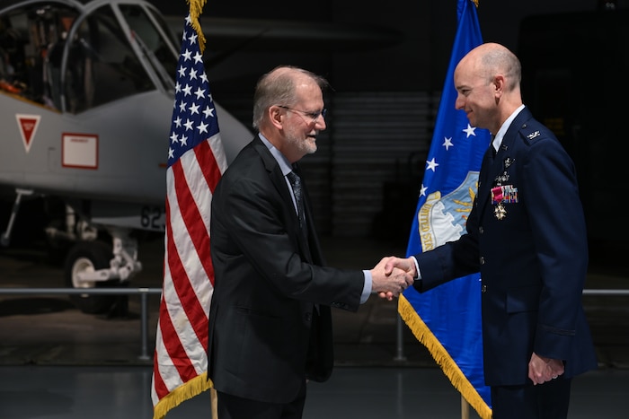 Steven D. Wert, left, presents Col. Scott Rothermel with the Legion of Merit during a retirement ceremony April 24, at the Museum of Aviation here. Rothermel, the senior materiel leader for Command and Control, Intelligence, Surveillance, and Reconnaissance retired after 30 years of service. Wert is a member of the Senior Executive Service and the Deputy Assistant Secretary for Acquisition Integration, Office of the Assistant Secretary of the Air Force for Acquisition, Technology and Logistics, the Pentagon, Arlington, Va. (Official Air Force Photo by Richard Blumenstein).