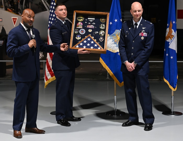 John Savoy, left, presents Col. Scott Rothermel with a shadow box during a retirement ceremony April 24, at the Museum of Aviation here. Rothermel, the senior materiel leader for Command and Control, Intelligence, Surveillance, and Reconnaissance retired after 30 years of service. Savoy is the deputy chief of C2ISR. (Official Air Force Photo by Richard Blumenstein).