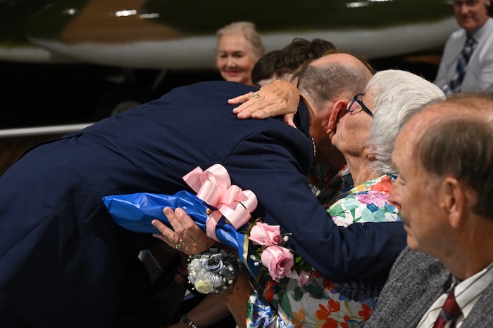 Col. Scott Rothermel embraces Marlene Rothermel, his mother, during a retirement ceremony April 24, at the Museum of Aviation here. Rothermel, the senior materiel leader for Command and Control, Intelligence, Surveillance, and Reconnaissance retired after 30 years of service. (Official Air Force Photo by Richard Blumenstein).
