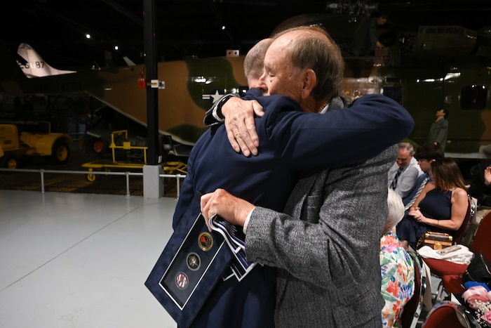 Col. Scott Rothermel embraces Robert Rothermel, his father, during a retirement ceremony April 24, at the Museum of Aviation here. Rothermel, the senior materiel leader for Command and Control, Intelligence, Surveillance, and Reconnaissance retired after 30 years of service. (Official Air Force Photo by Richard Blumenstein).