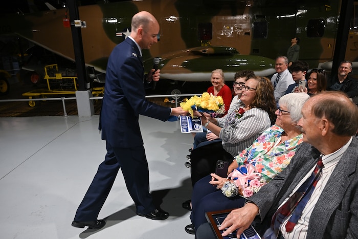 Col. Scott Rothermel presents flowers to Leigh Rothermel, his wife, during a retirement ceremony April 24, at the Museum of Aviation here. Rothermel, the senior materiel leader for Command and Control, Intelligence, Surveillance, and Reconnaissance retired after 30 years of service. (Official Air Force Photo by Richard Blumenstein).
