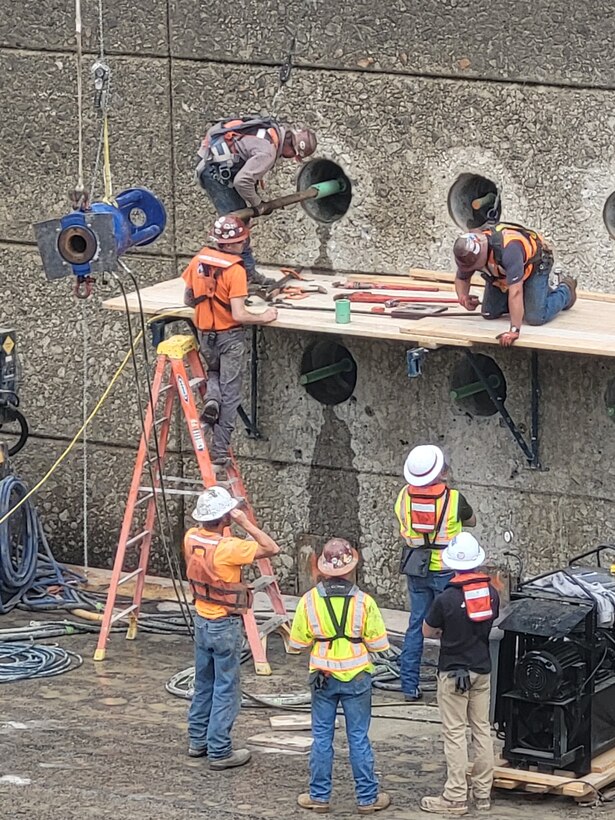 Picture of men working on a lock.