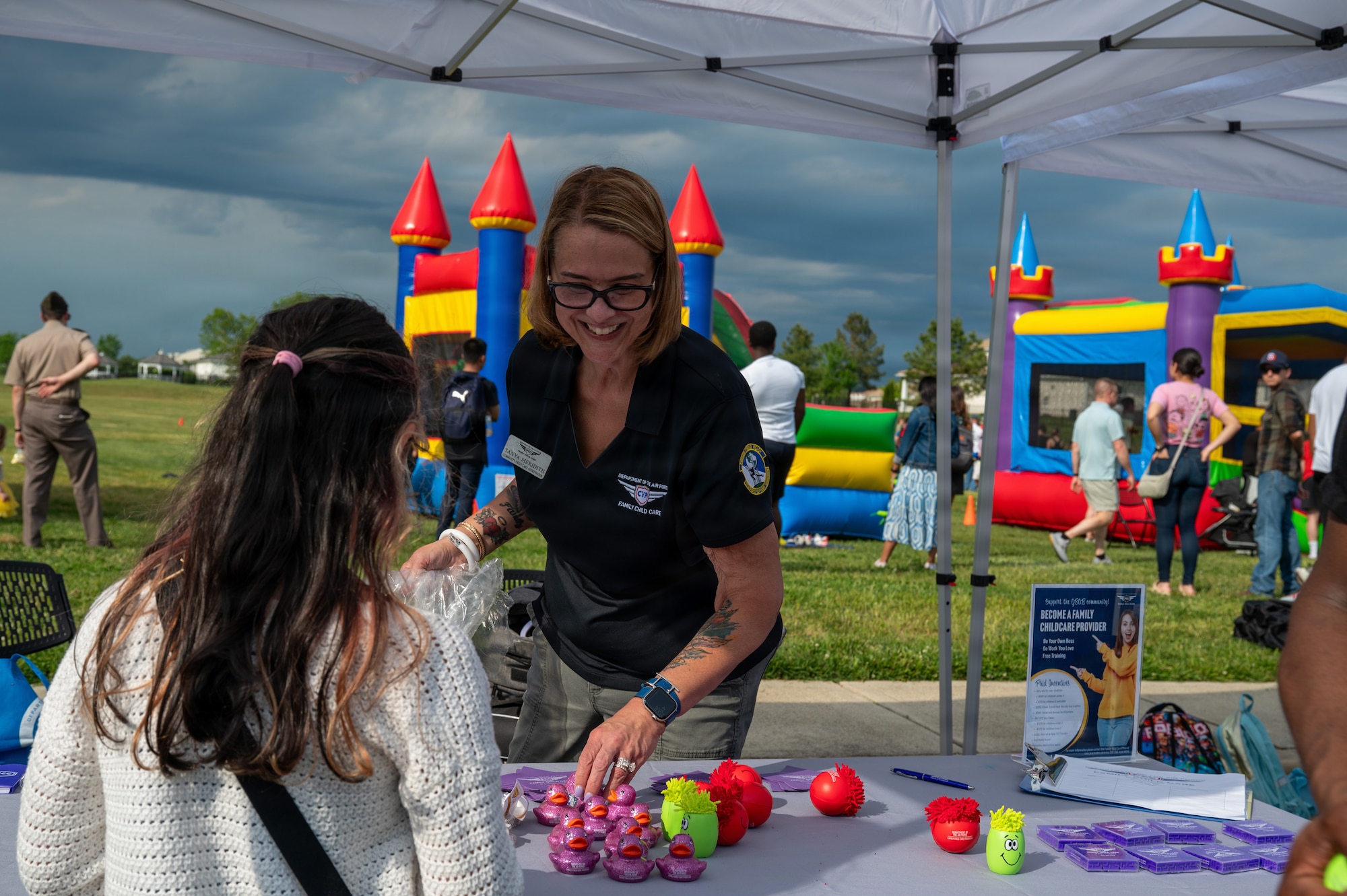 Tanya Meridith, right, community childcare coordinator with the 11th Force Support Squadron, gives away toys at Spring Fest on Joint Base Anacostia-Bolling, Washington, D.C., April 24, 2026. The 11th Force Support Squadron hosted the event in celebration of the Month of the Military Child. (U.S. Air Force photo by Airman 1st Class Arlene Carrara)