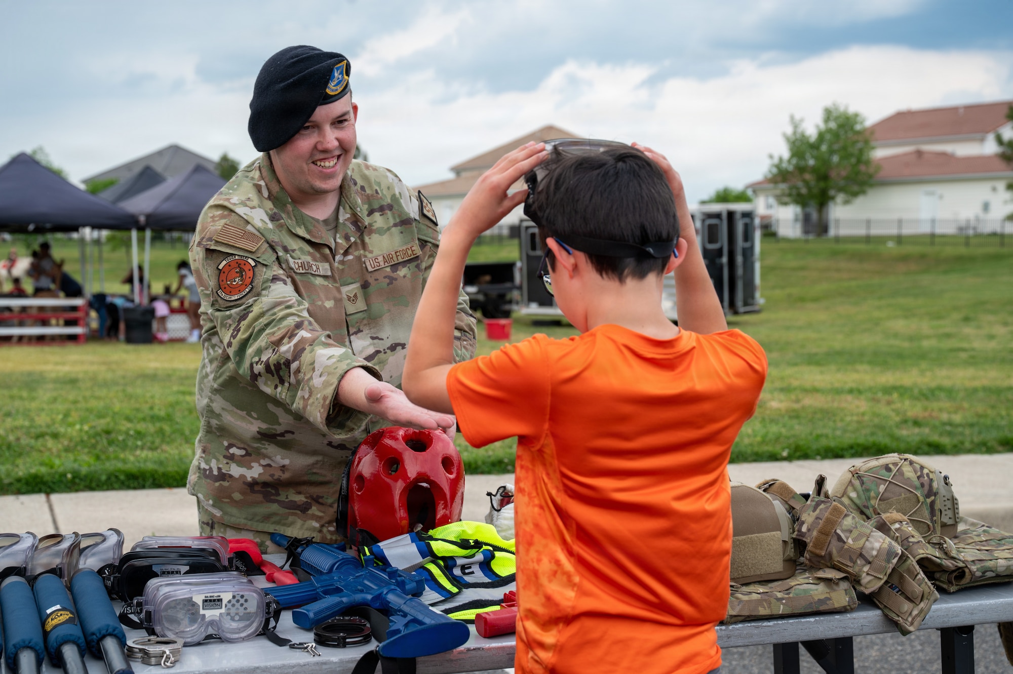 U.S. Air Force Staff Sgt. Kesler Church, left, operations flight sergeant with the 11th Security Forces Squadron, exhibits security forces gear at Spring Fest on Joint Base Anacostia-Bolling, Washington, D.C., April 24, 2026. The 11th Force Support Squadron hosted the event in celebration of the Month of the Military Child. (U.S. Air Force photo by Airman 1st Class Arlene Carrara)