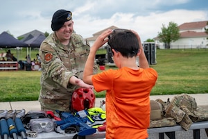 U.S. Air Force Staff Sgt. Kesler Church, left, operations flight sergeant with the 11th Security Forces Squadron, exhibits security forces gear at Spring Fest on Joint Base Anacostia-Bolling, Washington, D.C., April 24, 2026. The 11th Force Support Squadron hosted the event in celebration of the Month of the Military Child. (U.S. Air Force photo by Airman 1st Class Arlene Carrara)