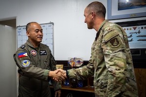 Philippine Air Force Lt. Col. Alexander Ilagan, 600th Air Base Group deputy commander, left, greets Col. Paul Julian, 21st Air Expeditionary Wing deputy commander, right, during Exercise Balikatan 2026 at Clark Air Base, Philippines, April 21, 2026. Leadership from the 21st AEW and the 600th ABG met to strengthen interoperability and explore integration opportunities in support of BK26. (U.S. Air Force photo by Airman 1st Class Adrien Tran)