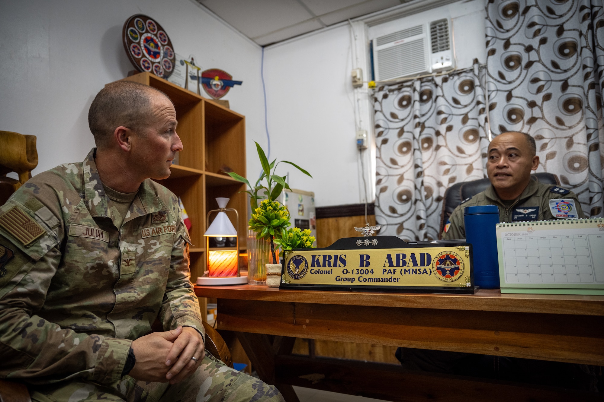 U.S. Air Force Col. Paul Julian, 21st Air Expeditionary Wing deputy commander, left, and Philippine Air Force Lt. Col. Alexander Ilagan, 600th Air Base Group deputy commander, right, discuss potential integration and outreach opportunities for Airmen during Exercise Balikatan 2026 at Clark Air Base, Philippines, April 21, 2026. The 21st AEW met with leadership from the 600th Air Base Group to coordinate support opportunities for both groups during BK26. (U.S. Air Force photo by Airman 1st Class Adrien Tran)