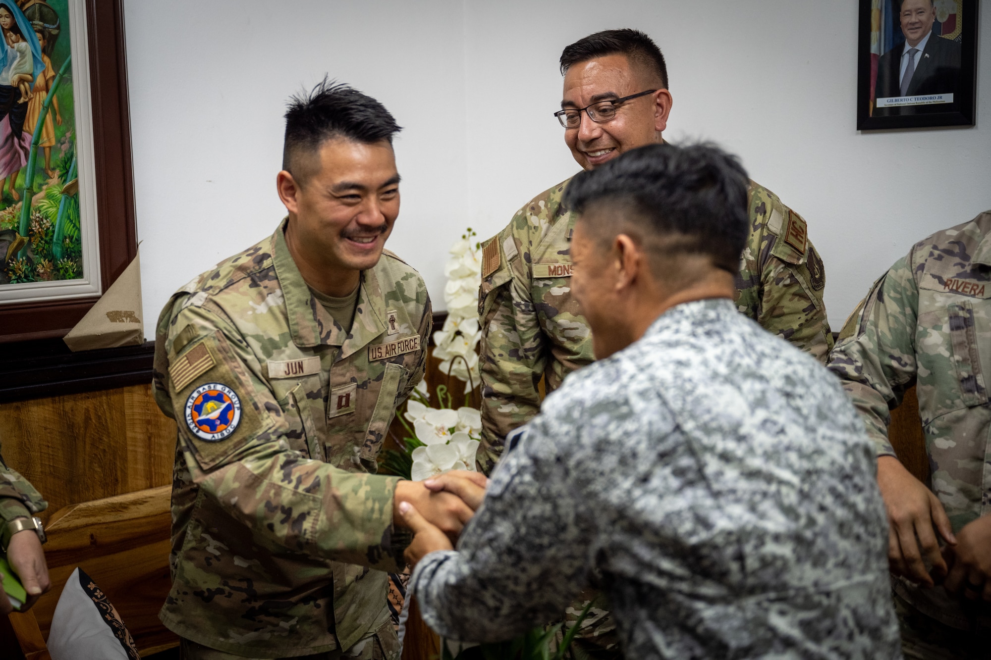 U.S. Air Force Capt. Joseph Jun, 21st Air Expeditionary Wing chaplain, greets Philippine Air Force Airmen assigned to the 600th Air Base Group during Exercise Balikatan 2026 at Clark Air Base, Philippines, April 21, 2026. The 21st AEW is trained and equipped to provide humanitarian and civic assistance for local Filipino communities. (U.S. Air Force photo by Airman 1st Class Adrien Tran)