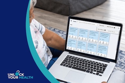 Unlock Your Health logo; Person uses a laptop while sitting on a couch.