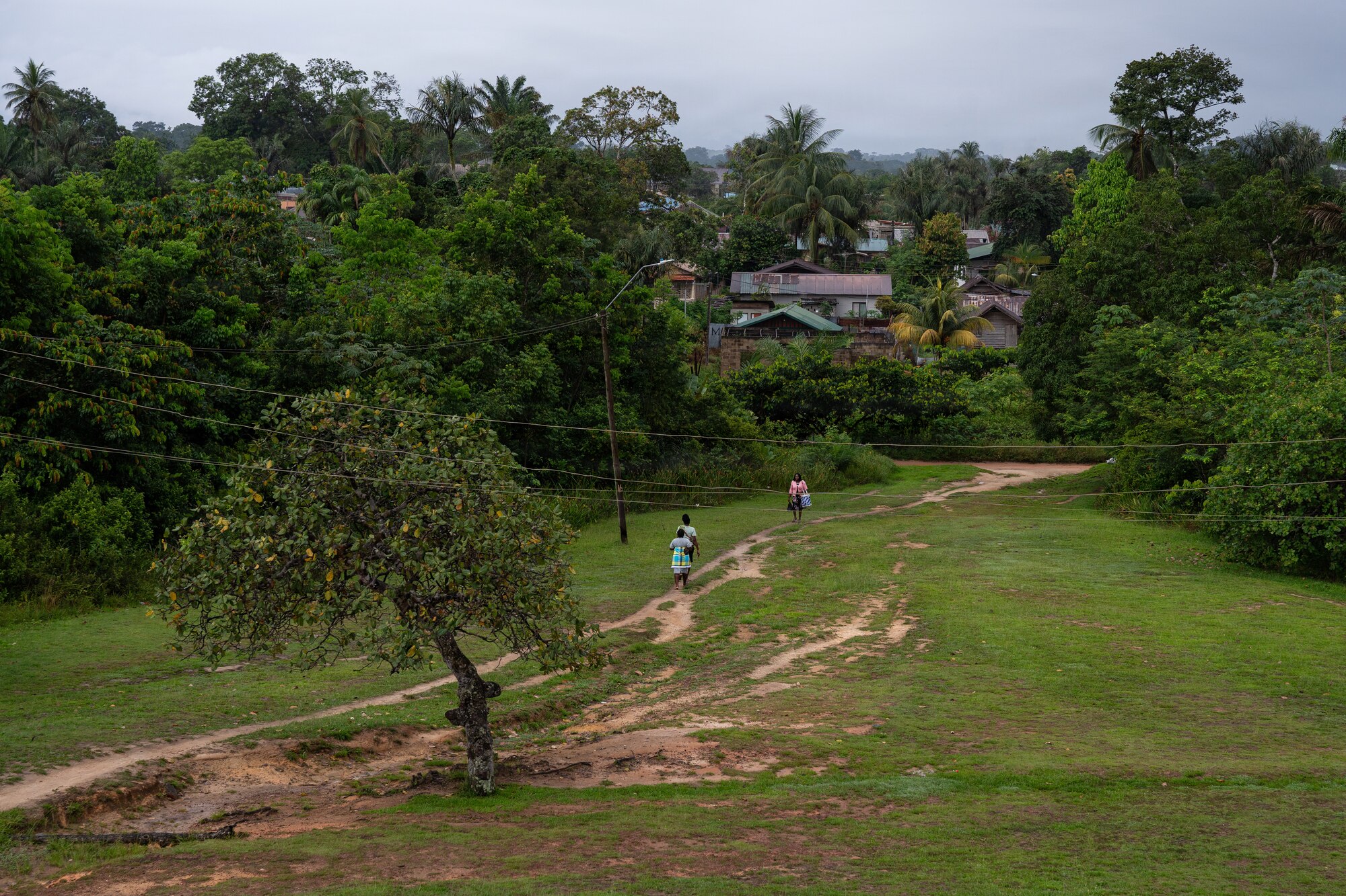 Surinamese patients walk toward the Medische Zending Primary Health Care Center in Brownsweg, Suriname, during a Lesser Antilles Medical Assistance Team (LAMAT) 2026 mission, April 15, 2026. The mission is the second LAMAT engagement in Suriname, reinforcing continued partnership through medical collaboration, patient care, and knowledge exchange. (U.S. Air Force photo by Staff Sgt. Joshua Hastings)