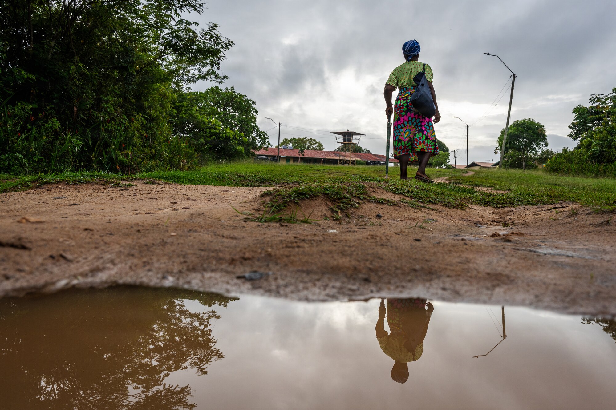 A Surinamese woman walks toward the Medische Zending Primary Health Care Center in Brownsweg, Suriname, during a Lesser Antilles Medical Assistance Team (LAMAT) 2026 mission, April 15, 2026. LAMAT 2026 enhances readiness and partnerships by enabling U.S. and Surinamese providers to deliver side-by-side care while strengthening coordination in emergency medicine. (U.S. Air Force photo by Staff Sgt. Joshua Hastings)