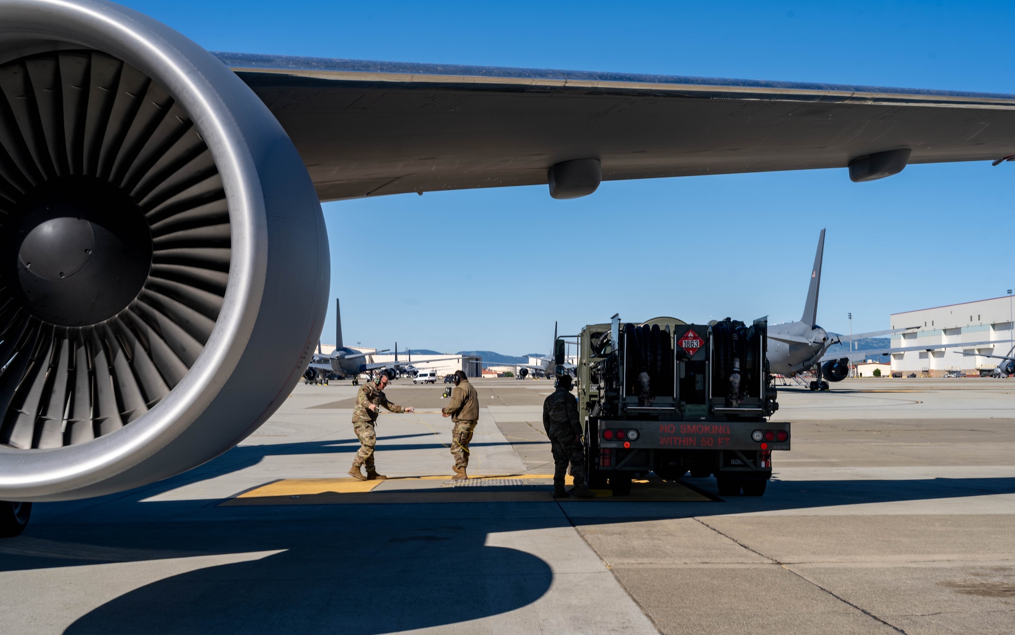 Two U.S. Airmen prepare to fuel a KC-47 Pegasus at Travis Air Force Base.