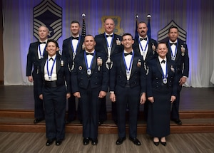 A group of people in military uniform pose for a group photo.