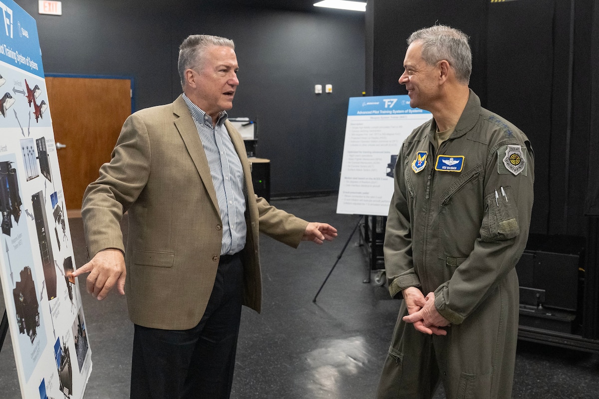 Stephen Dobronski, Boeing flight simulator design engineer, briefs Air Force Chief of Staff Gen. Ken Wilsbach on the capacities of the T-7A Red Hawk Ground-Based Training System during Wilsbach’s Joint Base San Antonio immersion tour at JBSA-Randolph, Texas, April 22, 2026. Wilsbach is touring the 12th Flying Training Wing during his JBSA tour to examine the Wing’s capabilities to contribute to the generation of airpower and to empower Airmen to innovate.
