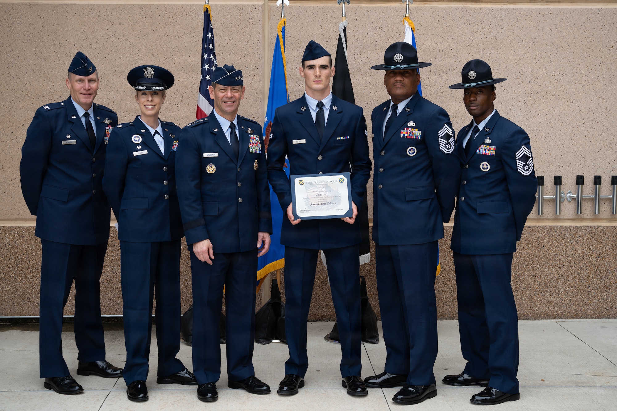 U.S. Air Force Chief of Staff Gen. Ken Wilsbach, third from left, poses for a photo with Airman 1st Class Lucas Estes, Basic Military Training top graduate, and leaders with the 737th Training Group at Joint Base San Antonio-Lackland, Texas, April 23, 2026. Estes earned top graduate honors upon completion of 7 1/2 weeks of Basic Military Training.
