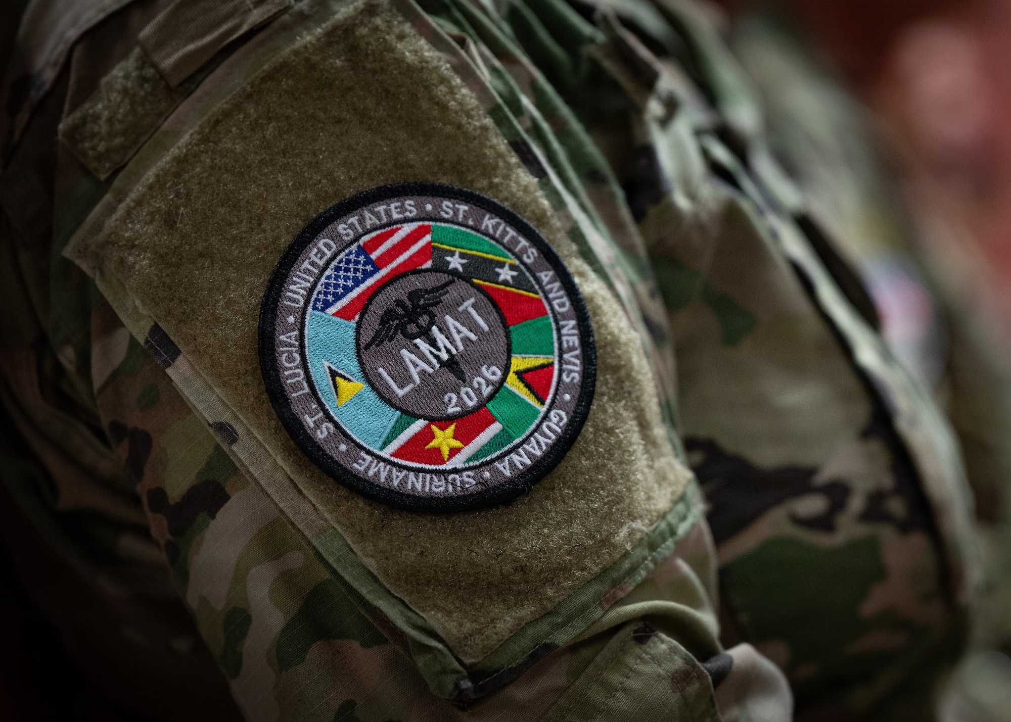 A U.S. Airman attends the closing ceremony of the Lesser Antilles Medical Assistance Team (LAMAT) 2026 mission in Paramaribo, Suriname, April 23, 2026. The LAMAT 2026 team collectively treated a total of 2,000 patients, provided over 3,000 eyeglasses and conducted 432 knowledge exchange hours together with their counterparts in Suriname. (U.S. Air Force photo by Staff. Sgt. Madeline Herzog)