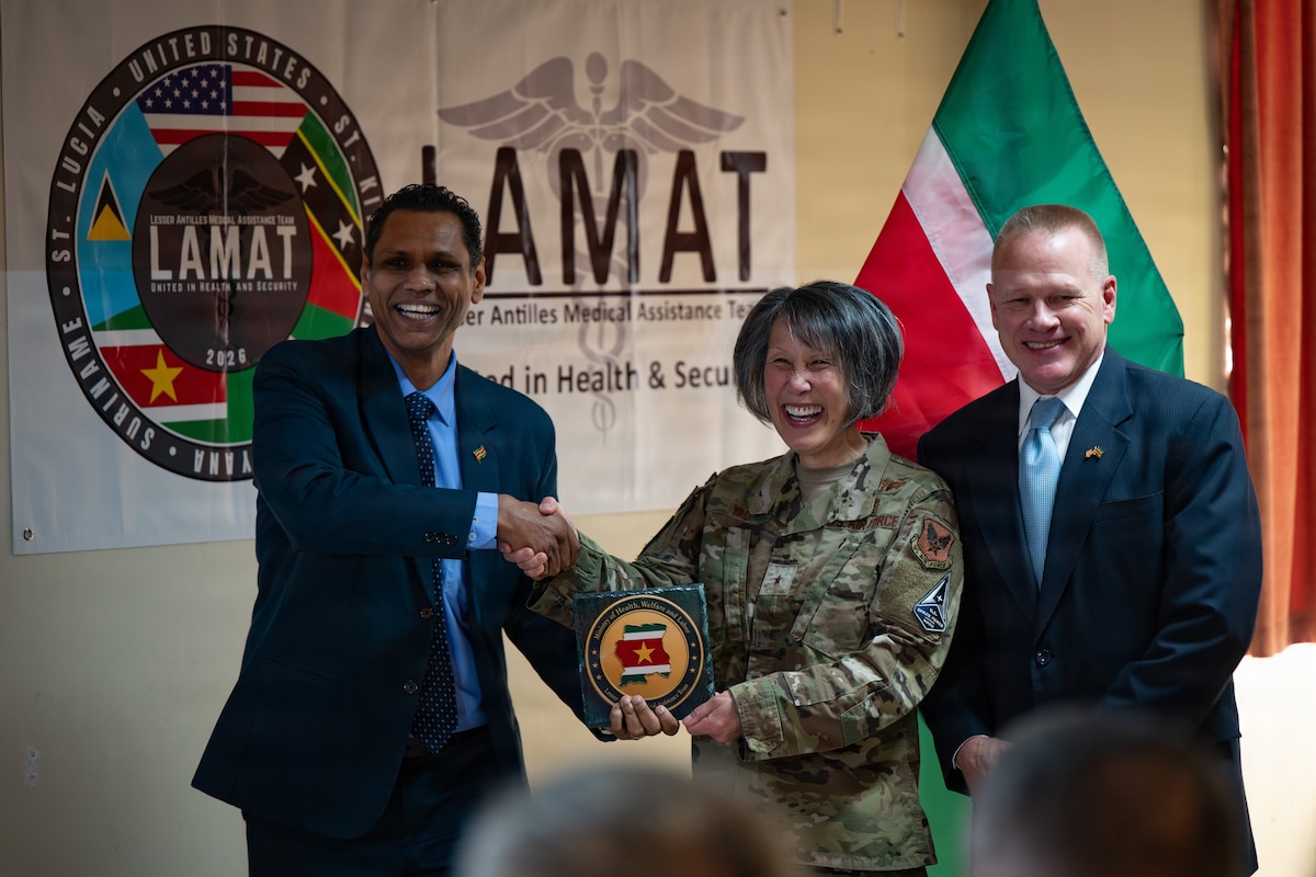 Dr. Rakesh Sukul, Ministry of Health director, U.S. Air Force Brig. Gen. Eveline Yao, Air Force Medical Command special assistant to the commander, and Paul Watzlavick, Chargé d'Affaires, U.S. Embassy Paramaribo, exchange tokens of appreciation during the closing ceremony of the Lesser Antilles Medical Assistance Team (LAMAT) 2026 mission in Paramaribo, Suriname, April 23, 2026. The ceremony commemorated the partnership between the U.S. and Suriname, highlighting the important role of medical engagements and the value of building critical relationships between medical personnel from both countries. (U.S. Air Force photo by Staff. Sgt. Madeline Herzog)